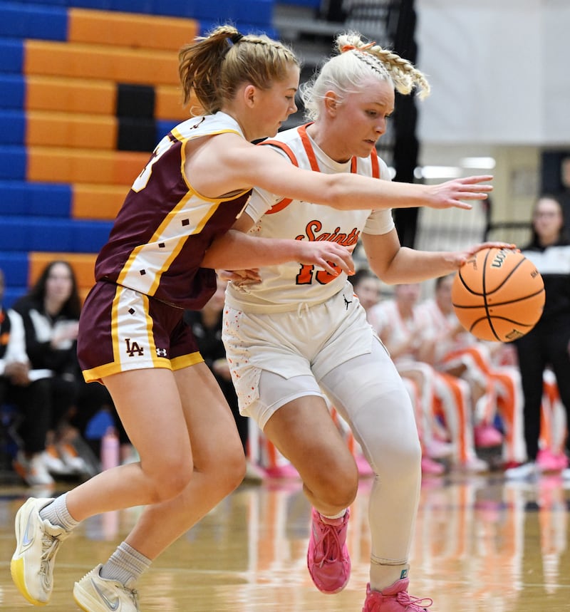 St. Charles East's Addie Schilb, right, drives against Loyola Academy defender Marycait Mackie during the Class 4A girls basketball supersectional at Hoffman Estates High School on Monday, March 2, 2026.