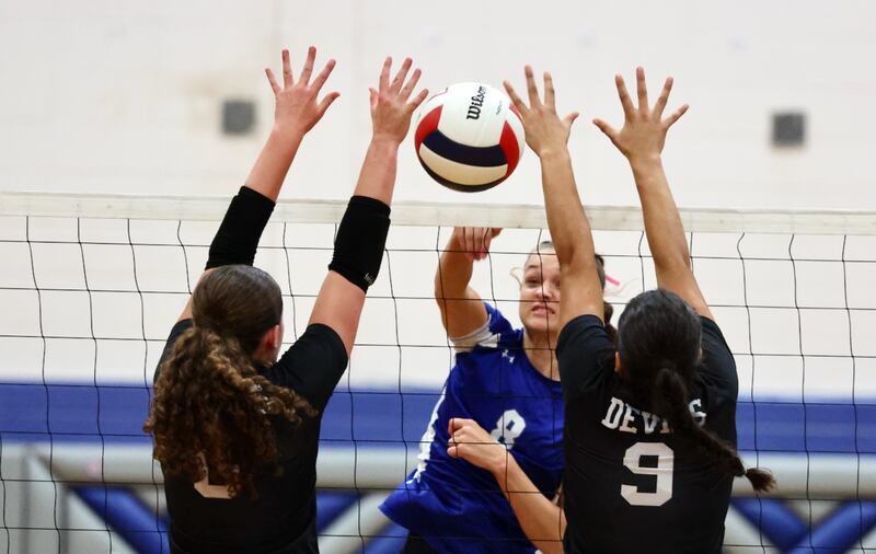 Princeton's Keighley Davis hits the ball between Hall's Kaitlyn Coutts (left) and Natalia Zamora on Tuesday, Sept. 16, 2025 in Princeton.