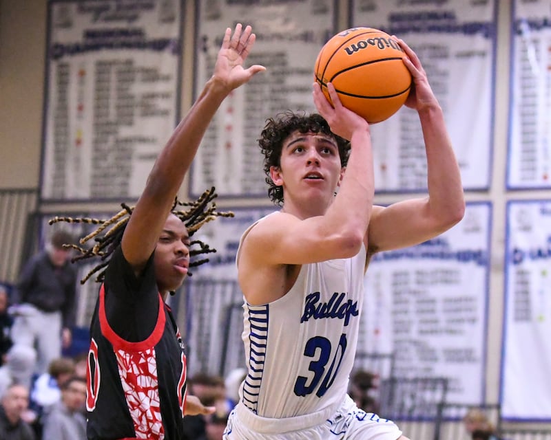 Riverside-Brookfield's Liam Enright (30) takes a shot after getting around Glenbard East's Cameron Bonner (10) during the game on Tuesday Feb. 3, 2026, held at Riverside-Brookfield High School.