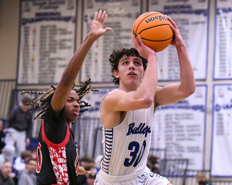 Riverside-Brookfield's Liam Enright (30) takes a shot after getting around Glenbard East's Cameron Bonner (10) during the game on Tuesday Feb. 3, 2026, held at Riverside-Brookfield High School.