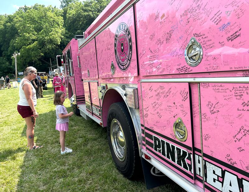 Sawyer Schindel, 5, and her mom, Candice, of Tampico, check out the Pink Heals Fire Engine when it showed up at the Rock River Riders Motorcycle Club's Father Day Hill Climb on Sunday, June 15, 2025.