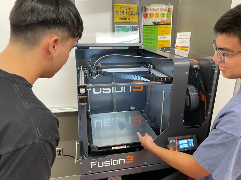 Kishwaukee College students Jayson Quintero and Irving Escalante using physics and engineering lab Fusion3 3D printer