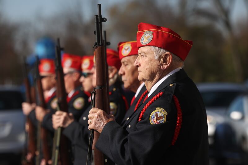 The Memorial Squad stands at attention during the playing of Taps at the Veterans Day service at the American Legion Post 1080 in Joliet on Friday.