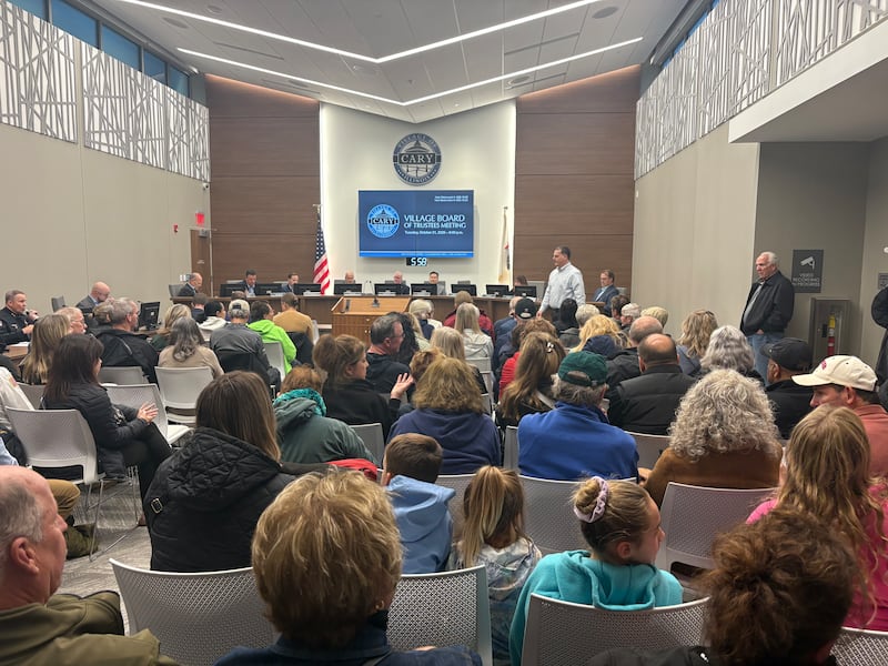 Over 100 residents attend the Cary Village Board meeting in opposition of a proposed road extension to New Haven Drive on Oct. 21, 2025.