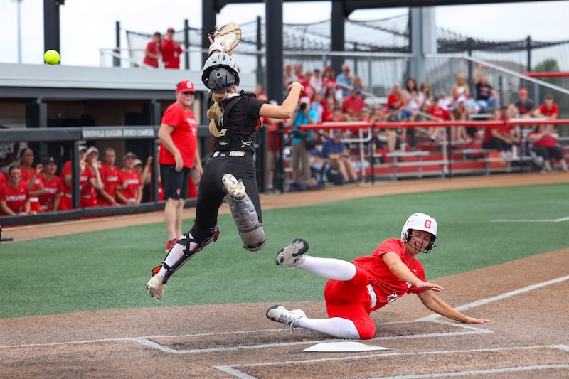 Prairie Ridge's catcher Kendra Carroll misses a throw to home as Glenwood's Gracyn Lewis scores during the Wolves' 5-0 loss to Glenwood in the IHSA Class 3A state semifinal on June 13, 2025.