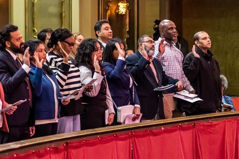 New U.S. citizens take the Oath of Allegiance during the Naturalization Ceremony at Rialto Square Theatre in Joliet on April 17, 2025.