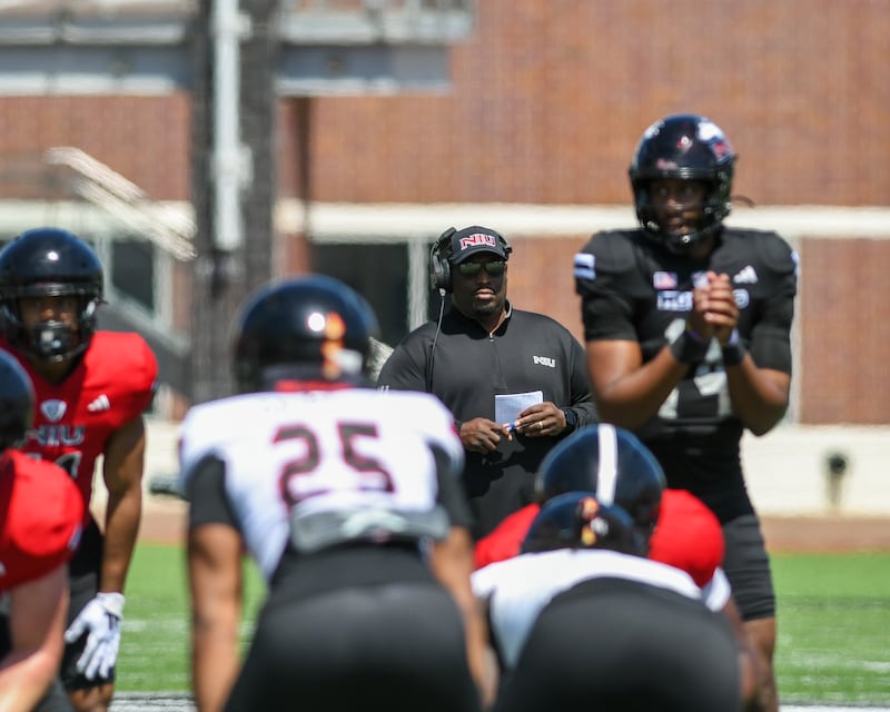 Northern Illinois University's head coach Thomas Hammock, center, looks on during practice on Saturday April 26, 2025, held at Huskie Stadium in DeKalb.