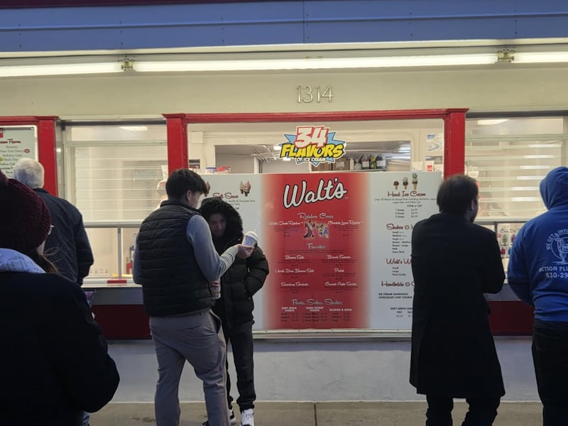 People line up after sunset for ice cream on opening day for Walt's Ice Cream in Joliet on Sunday, March 1, 2026. The day was sunny, but temperatures dropped into the 20s toward evening.