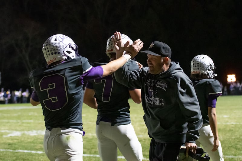 Wilmington's Ryan Kettman celebrates his touchdown with coach Jeff Reents during the Wildcats' 49-7 victory over Tri-Valley in the quarterfinal game on Saturday, Nov. 15, 2025.
