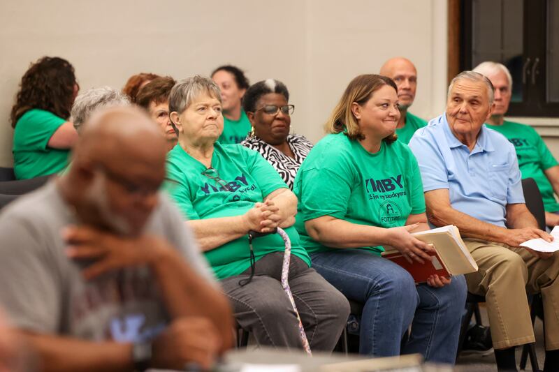 Surrounded by supporters, Dawn Broers, center, Fortitude Community Outreach founder and executive director, reacts as the Kankakee Planning Board voted 5-0 to approve a conditional use permit to allow a night shelter at 970 E. Court St. in Kankakee's 1st Ward. First Ward Alderpersons Michael Prude, at left, and Cherry Malone Marshall both voiced their opposition to the final approval, which will go before the city council in September.