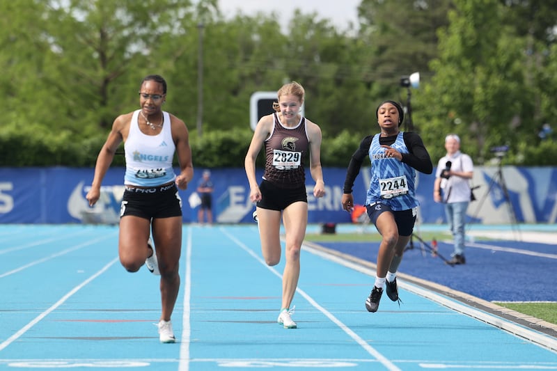 Sycamore’s Alyssa Stacy, center, finishes just behind Joliet Catholic’s Symone Holman, left, in the competes in the 200 m dash during the IHSA Class 2A Girls Track & Field State Finals on Saturday, May 24, 2025.