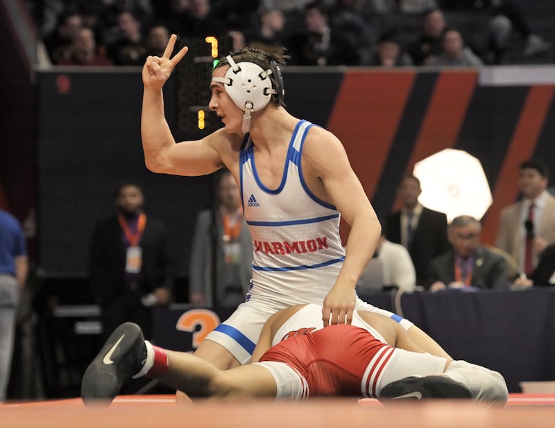 Marmion Academy’s Nicholas Garcia reacts in the final seconds as he beats Michael Esteban of Marist in the Class 3A 126-pound final at the IHSA boys state wrestling championships at the State Farm Center in Champaign on Saturday, Feb. 22, 2025.
