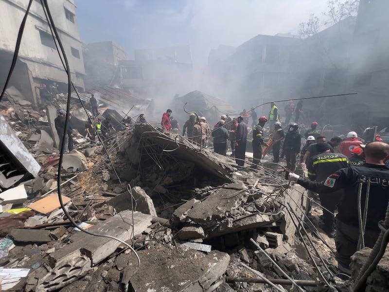 Rescue workers search for victims at the site of an Israeli airstrike that hit a crowded neighbourhood south of Beirut, Lebanon, Sunday, April 5, 2026. (AP Photo/Hussein Malla)