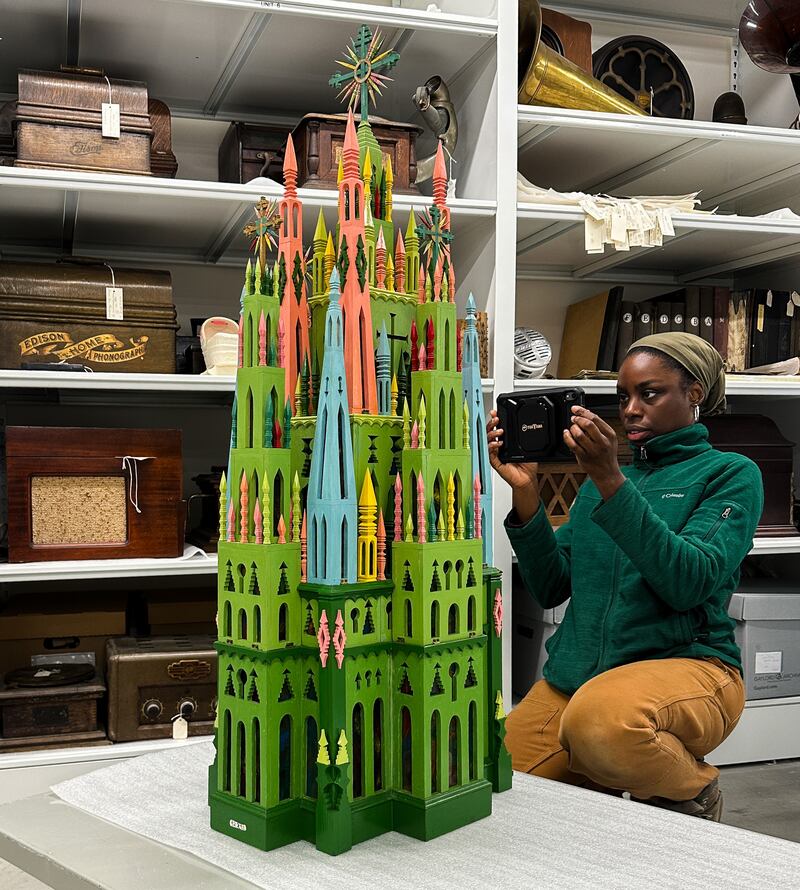 A professional art handler readies a carved cathedral from the Dunn Museum for transport to the Intuit Art Museum in Chicago, where it is featured in a special exhibition.