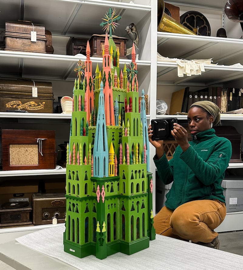 A professional art handler readies a carved cathedral from the Dunn Museum for transport to the Intuit Art Museum in Chicago, where it is featured in a special exhibition.