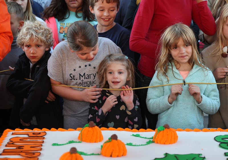 Kids are excited for a treat before the cake cutting ceremony Wednesday, Oct. 23, 2024, near the DeKalb County Courthouse during the Sycamore Pumpkin Festival. The cake was donated by the Sycamore Hy-Vee.