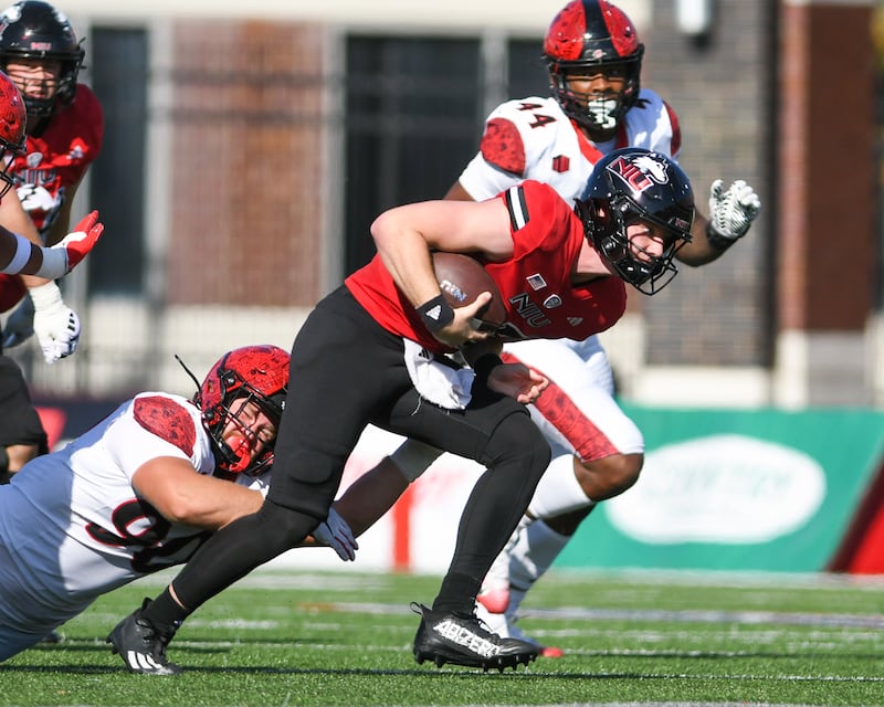 Northern Illinois University's quarterback Josh Holst (15) runs the before being tripped up by Sand Diego State university during the game on Saturday Sept. 27, 2025, held at Huskie Stadium in DeKalb.