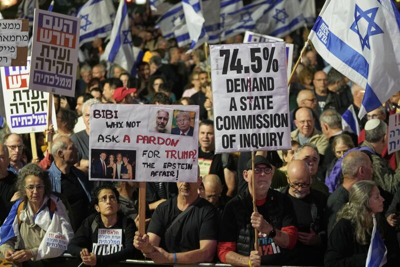 People take part in a protest against Prime Minister Benjamin Netanyahu's government and call for a state commission of inquiry to investigate the events of the Hamas militant group attack of October 7, 2023, as they gather at Habima square, in Tel Aviv, Israel, Saturday, Nov. 15, 2025. (AP Photo/Mahmoud Illean)