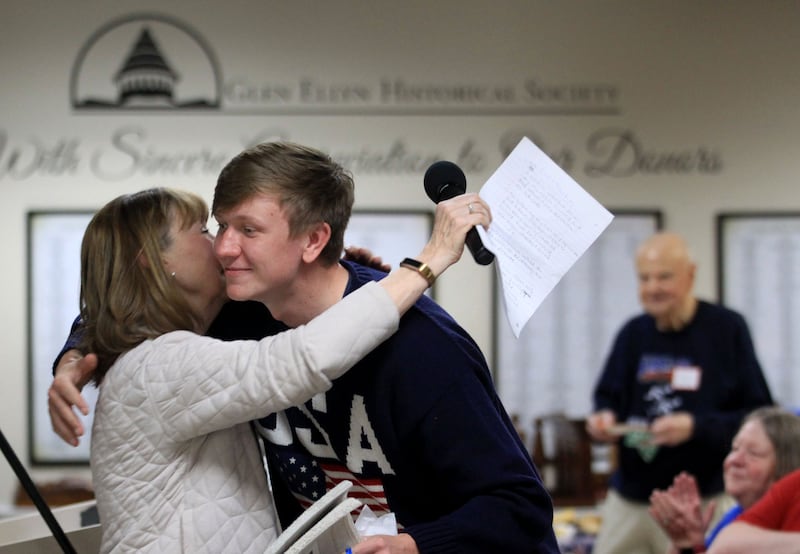 Olympic speed skater Ethan Cepuran embraces childhood teacher Debbie Rausch Sunday during a reception at the Glen Ellyn Historical Society