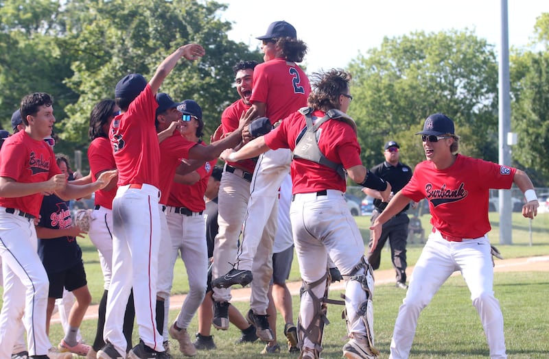 Members of the Burbank Senior League baseball team celebrate after defeating Michigan to win the Central Regional Baseball Tournament championship game on Thursday, July 18, 2024 at J.A. Happ Field in Washington Park in Peru.