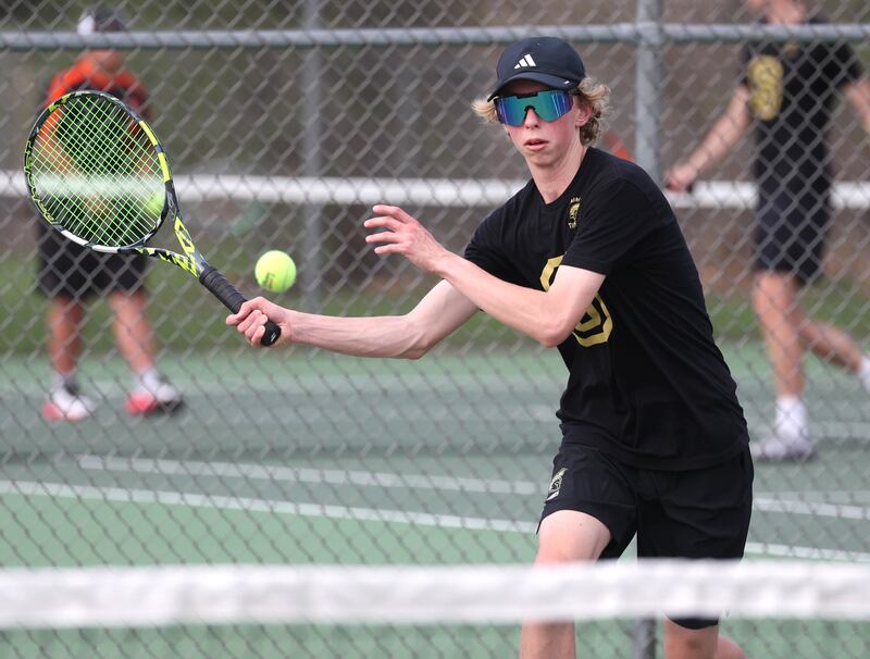 Sycamore number two singles player Luke Curtis returns a serve Thursday, April 24, 2025, during their match against DeKalb at Sycamore High School.