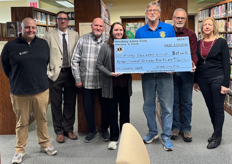 The Hinckley Public Library District receiving an $18, 266.87 Hinckley Lions Club donation