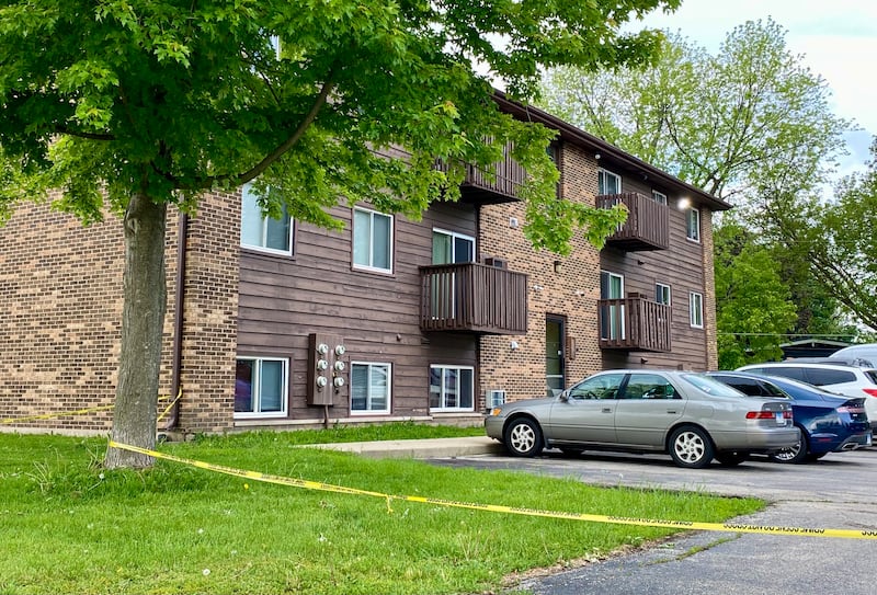 Crime scene police tape ropes off a portion of the parking lot off on Wednesday, May 28, 2025, at Russell Road Apartments, 822 Russell Road, DeKalb. One person suffered serious injuries in a mid-afternoon shooting outside the building, DeKalb Police Chief David Byrd said.