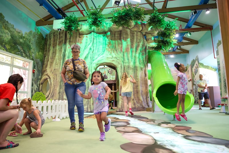 Children excitedly explore the Exploration Station's new Storybook Forest exhibit on Monday, June 23, 2025, during its grand opening event.