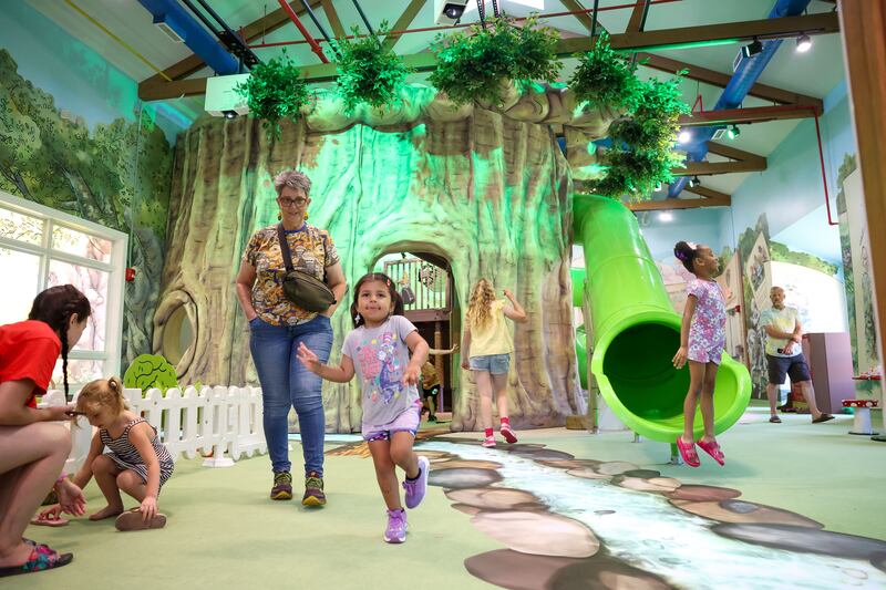 Children excitedly explore the Exploration Station's new Storybook Forest exhibit on Monday, June 23, 2025, during its grand opening event.