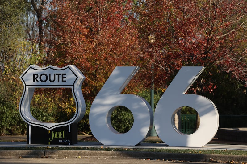 Fall color trees create a backdrop for the Route 66 sculpture at Joliet Kick On 66 Park in Joliet.
