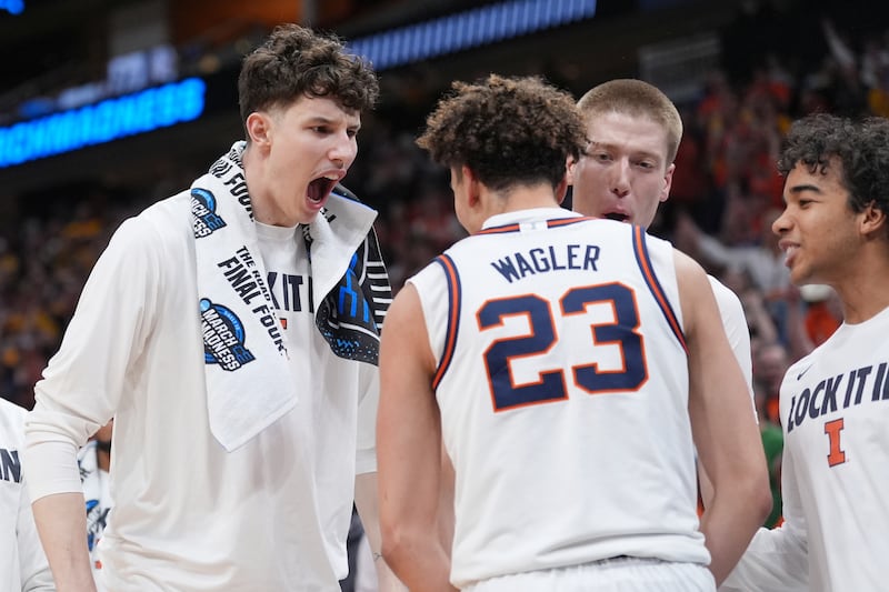 Illinois' Keaton Wagler (23) celebrates with teammates after making a basket while being fouled during the second half of an Elite Eight game against Iowa in the NCAA college basketball tournament Saturday, March 28, 2026, in Houston. (AP Photo/Eric Gay)