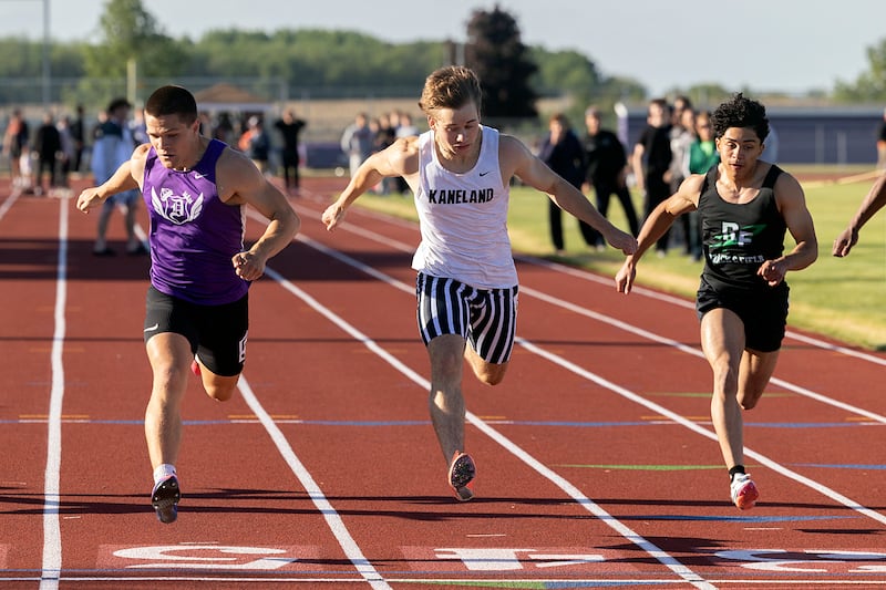 Dixon’s Owen Belzer (left) edges Kaneland’s Jackson Boryc in the 100 dash Wednesday, May 20, 2026, at the Rochelle Class 2A boys track sectionals.