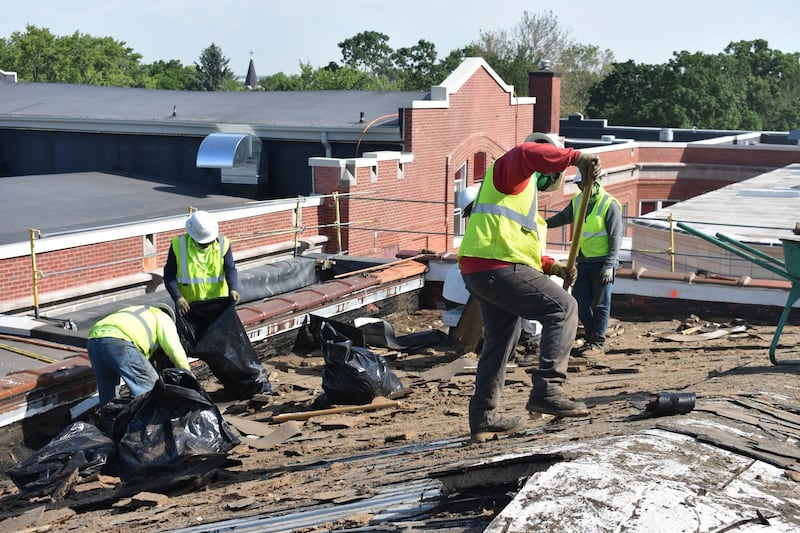Workers do repairs on the roof of Lockport Township High School Central Campus on Thursday, June 18, 2026.