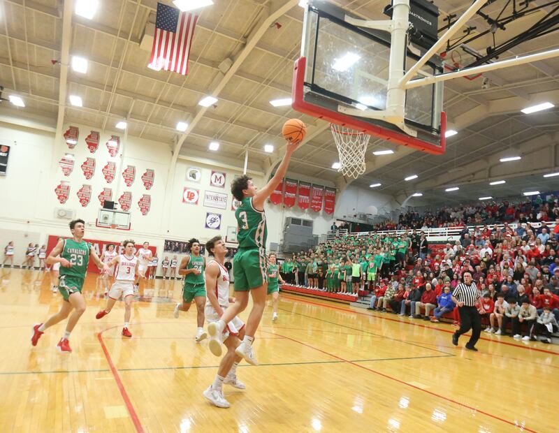 L-P's Mikey Hartman runs in to score over Streator's Matt Williamson during the Class 3A Regional title game on Friday, Feb. 28, 2025 in Sellett Gymnasium at L-P High School.