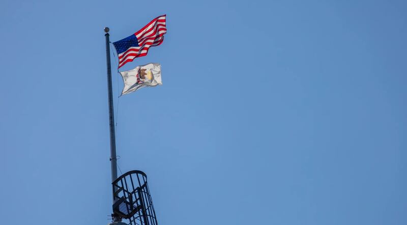 The U.S. and Illinois flags fly over the state capitol in Springfield