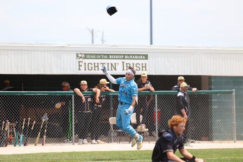Marquette's Anthony Couch tosses his helmet in celebration after hitting a walk-off two-run home run to secure Marquette's 4-3 victory over Bishop McNamara in the IHSA Class 2A Bishop McNamara Regional championship on Saturday, May 30, 2026.