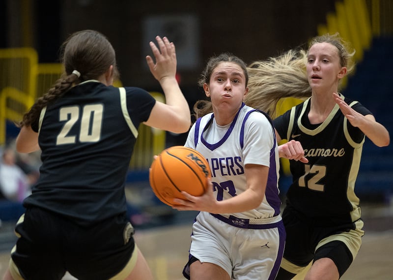 Plano’s Josie Larson drives to the hoop against Sycamore Monday, Feb. 17, 2025, during a 3A semifinal in Sterling.