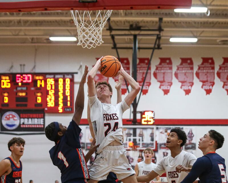 Yorkville's Nathan Kubin (24) puts up a shot underneath the basket during their basketball game between Oswego at Yorkville Friday, Dec 12, 2025 in Yorkville.