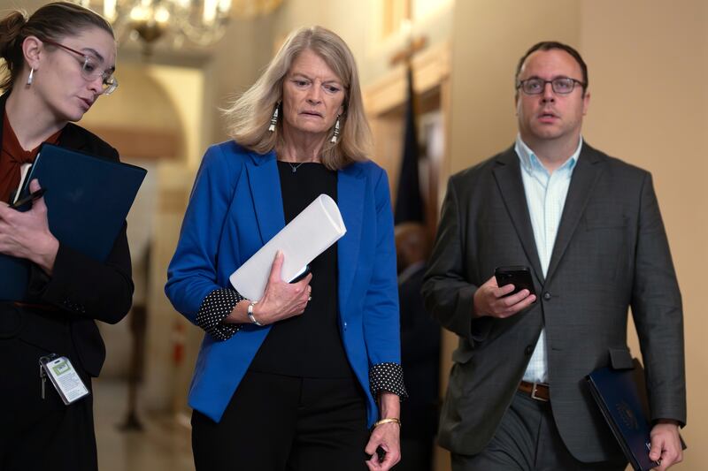 Sen. Lisa Murkowski, R-Alaska, center, a member of the Senate Appropriations Committee, arrives for a closed-door Republican meeting to advance President Donald Trump's sweeping domestic policy bill, at the Capitol in Washington, Friday, June 27, 2025. (AP Photo/J. Scott Applewhite)