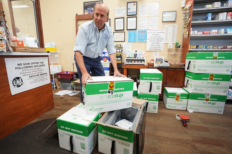 Co-owner Eric Abramowitz at Eric's Rx Shoppe unpacks a shipment of COVID-19 vaccines at the store in Horsham, Pa., Tuesday, Sept. 2, 2025. (AP Photo/Matt Rourke)
