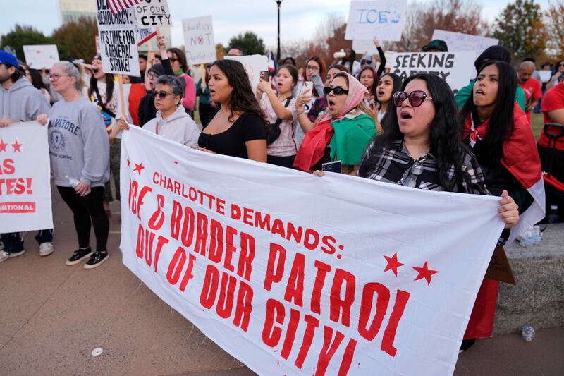 People protest against federal immigration enforcement Saturday, Nov. 15, 2025, in Charlotte, N.C. (AP Photo/Erik Verduzco)