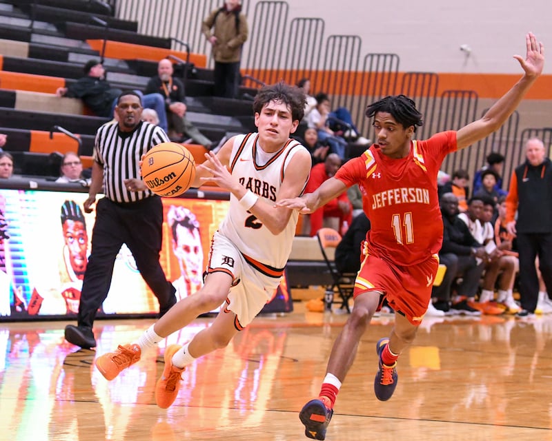 DeKalb's Aaron Ziga (2) drives to the lane and makes a basket while being defended by Jefferson's Malakhi Robinson (11) during the regional semifinal game on Wednesday Feb. 25, 2026, held at DeKalb High School.