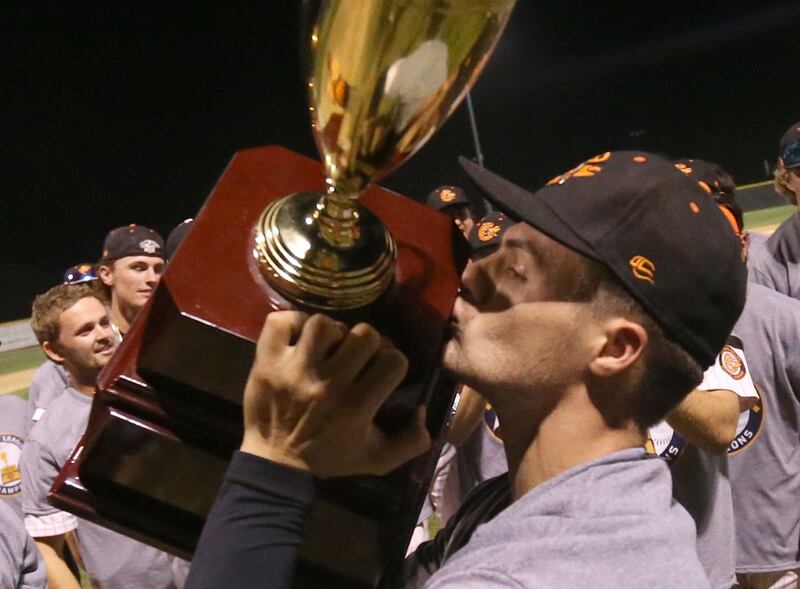 Pistol Shrimp's Jared Herzog of Ottawa, kisses the Prospect League trophy after winning the Prospect League Championship on Wednesday, Aug. 7, 2024 at Schweickert Stadium in Peru.
