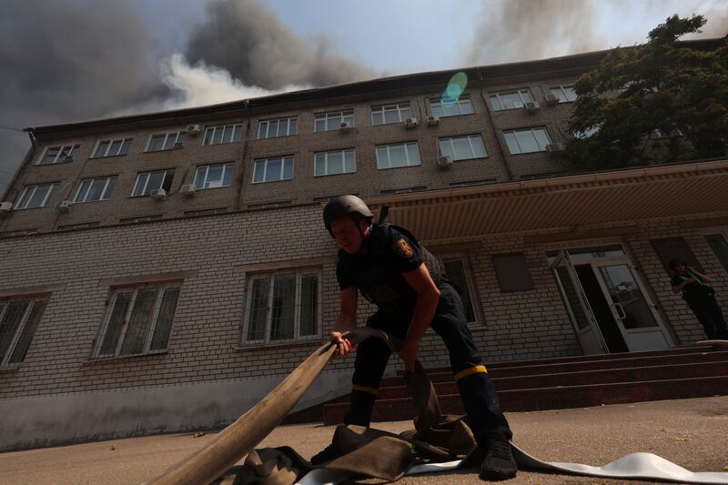 Rescue workers put out a fire of a building destroyed by a Russian drone strike in Zaporizhzhia, Ukraine, on Monday, July 7, 2025. (AP Photo/Kateryna Klochko)