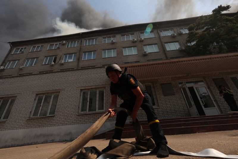 Rescue workers put out a fire of a building destroyed by a Russian drone strike in Zaporizhzhia, Ukraine, on Monday, July 7, 2025. (AP Photo/Kateryna Klochko)