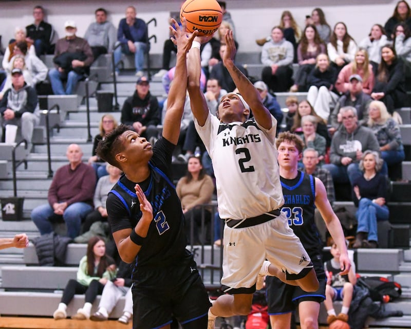 Kaneland's Isaiah Gipson, right, makes a basket while being fouled by St. Charles North's Euniel Mondesir (2) during the game on Wednesday Jan. 14, 2026, held at Kaneland High School.
