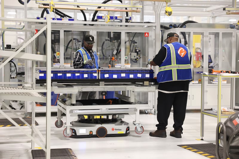 Workers complete a step in the assembly line at Gotion Illinois in Manteno on Oct. 1, 2025. The battery manufacturing plant has plans to expand its workforce to 450 jobs by the end of 2025, with the goal of reaching 1,400 jobs in 2026.