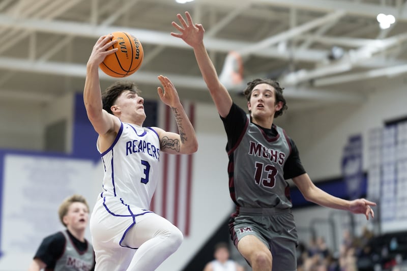 Plano's Ethan Taxis (3) glides in for a layup against the defense of Marengo's Myles Aukes (13) during Wednesday's game in Plano.