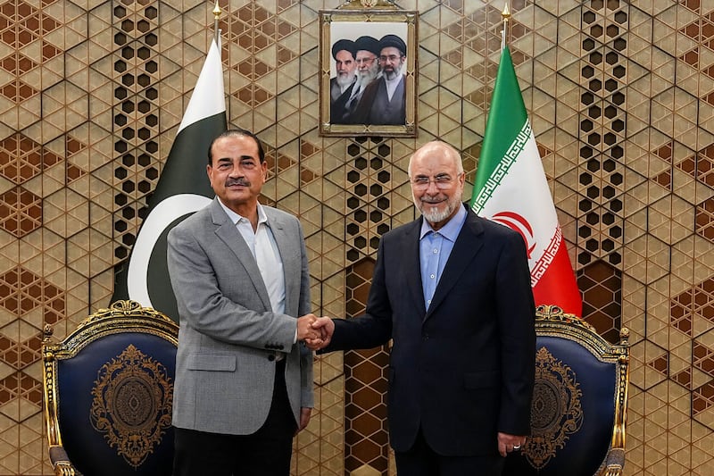 Iran's Parliament Speaker Mohammad Bagher Qalibaf, right, shakes hands with Pakistan's Army Chief Field Marshal Gen. Asim Munir during their meeting in Tehran, Iran, Sunday, May 23, 2026. (Hamed Malekpour/ICANA via AP)