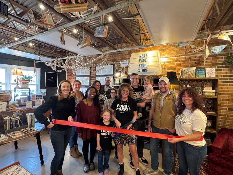 True North owners Stacey and Erik Olson, with their family, Morris Business Development Director Julie Wilkinson and Chamber President & CEO Christina Van Yperen, cut the ceremonial ribbon for their grand opening of the Next Page bookstore inside True North Building 2 March 14.